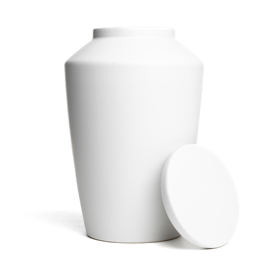 View of a white ceramic funeral urn with lid removed.