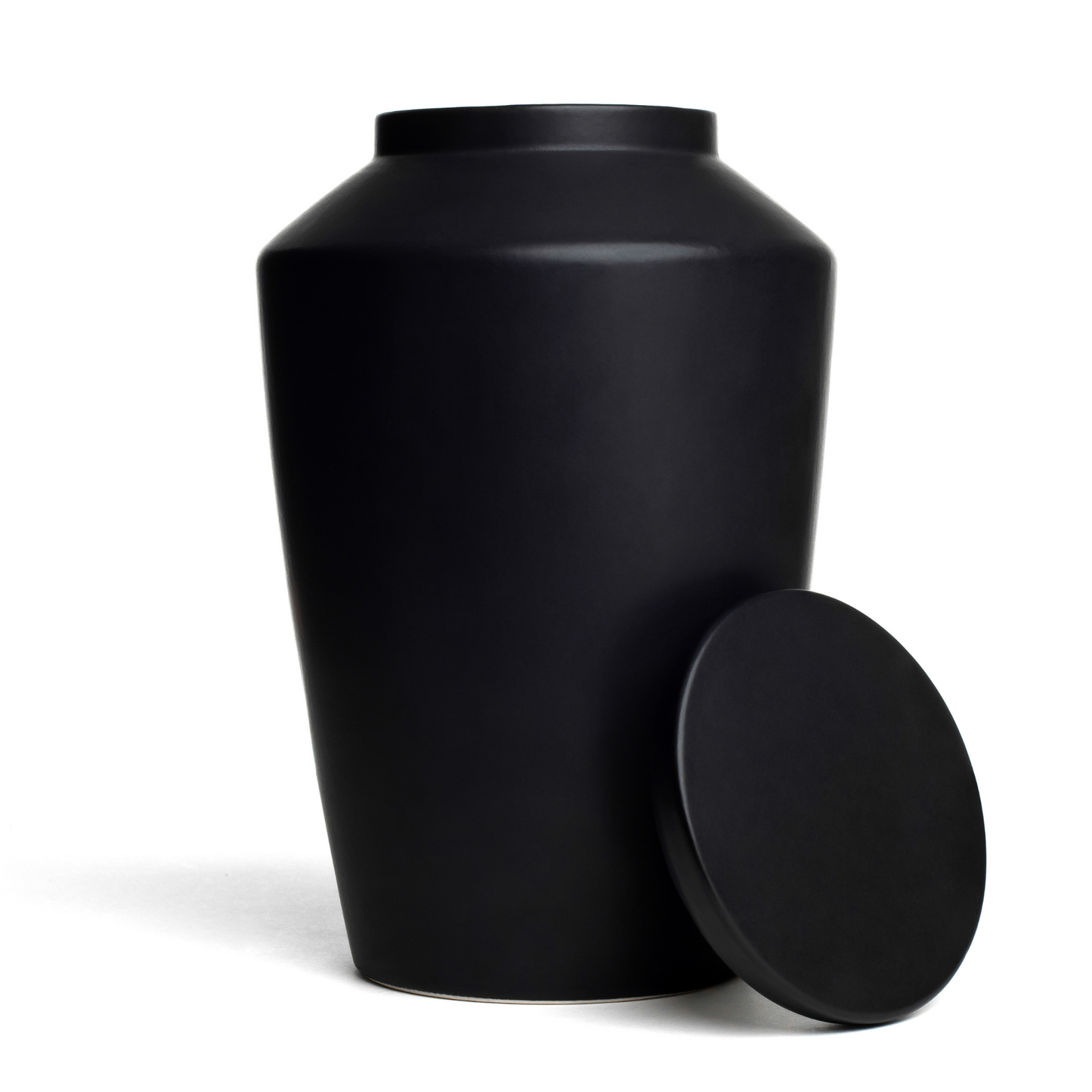 View of a black ceramic funeral urn with lid removed.