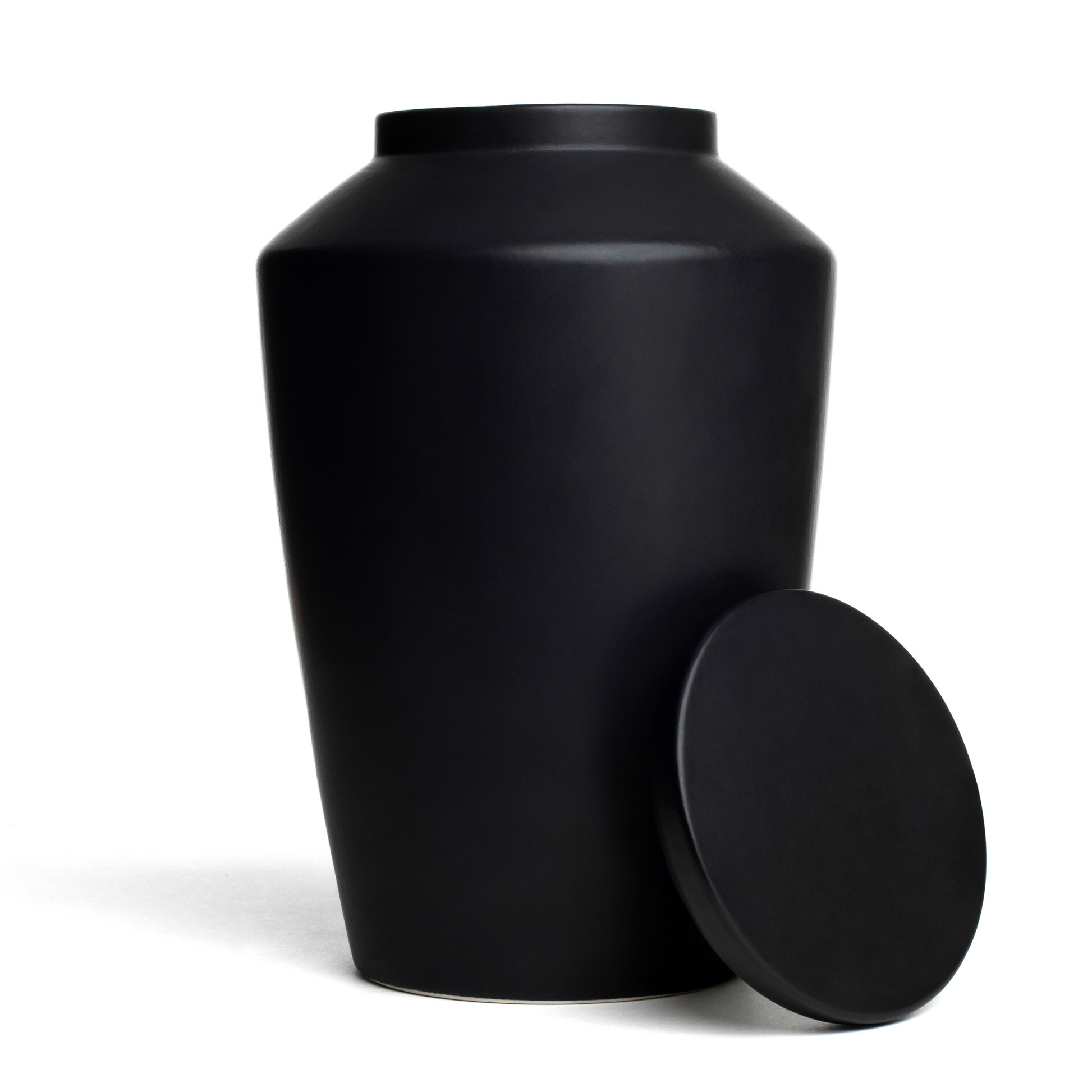 View of a black ceramic funeral urn with lid removed.