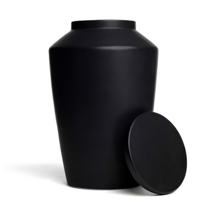 View of a black ceramic funeral urn with lid removed.