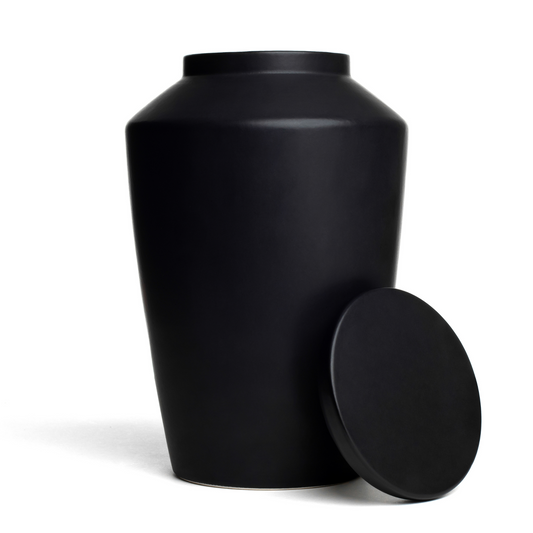 View of a black ceramic funeral urn with lid removed.
