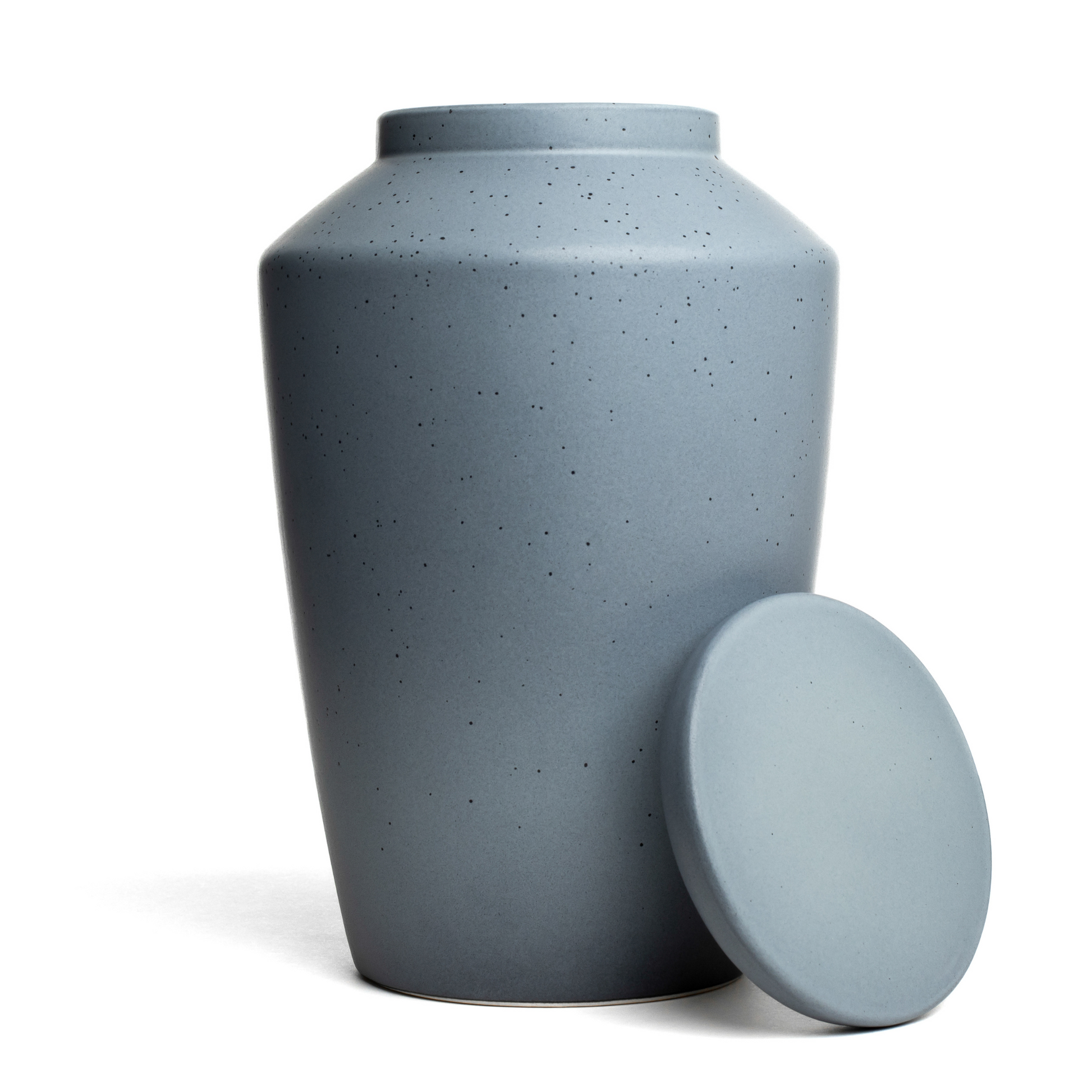 View of a speckled gray ceramic funeral urn with lid removed.