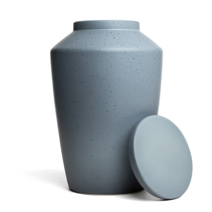 View of a speckled gray ceramic funeral urn with lid removed.