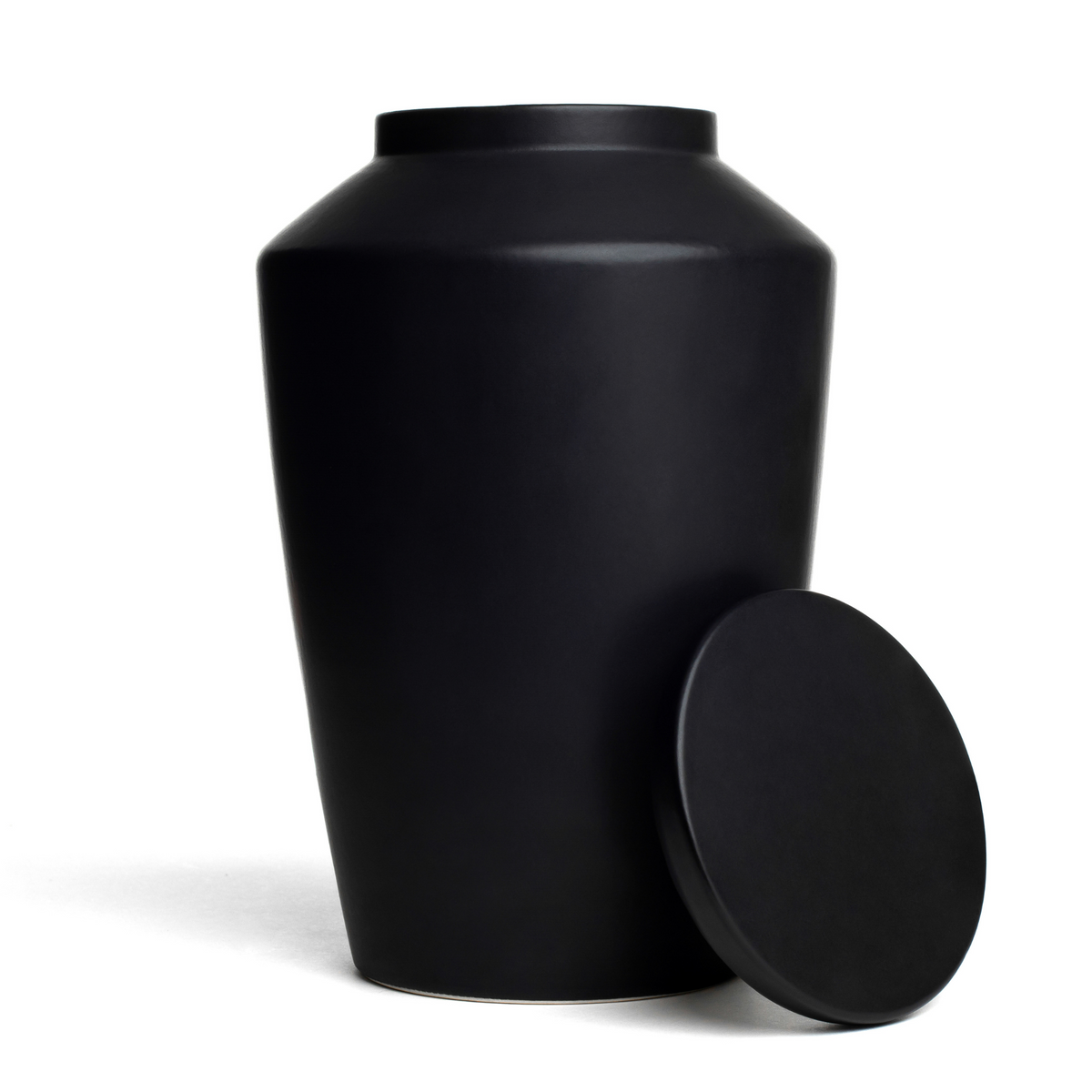 View of a black keepsake ceramic urn with lid removed.
