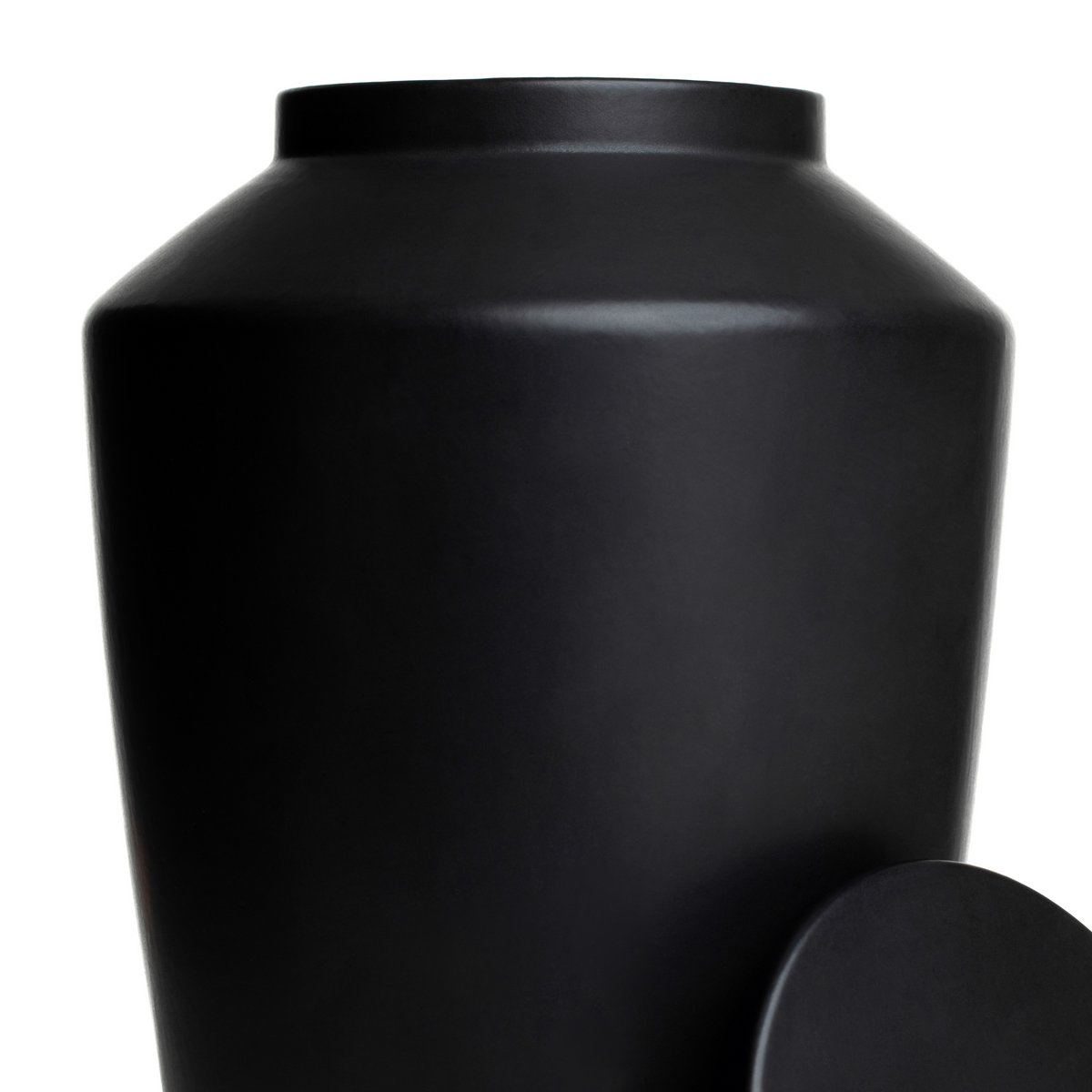 Macro detail of the smooth matte black glaze on a handcrafted stoneware keepsake urn.