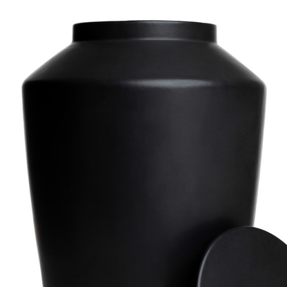 Macro detail of the smooth matte black glaze on a handcrafted stoneware keepsake urn.