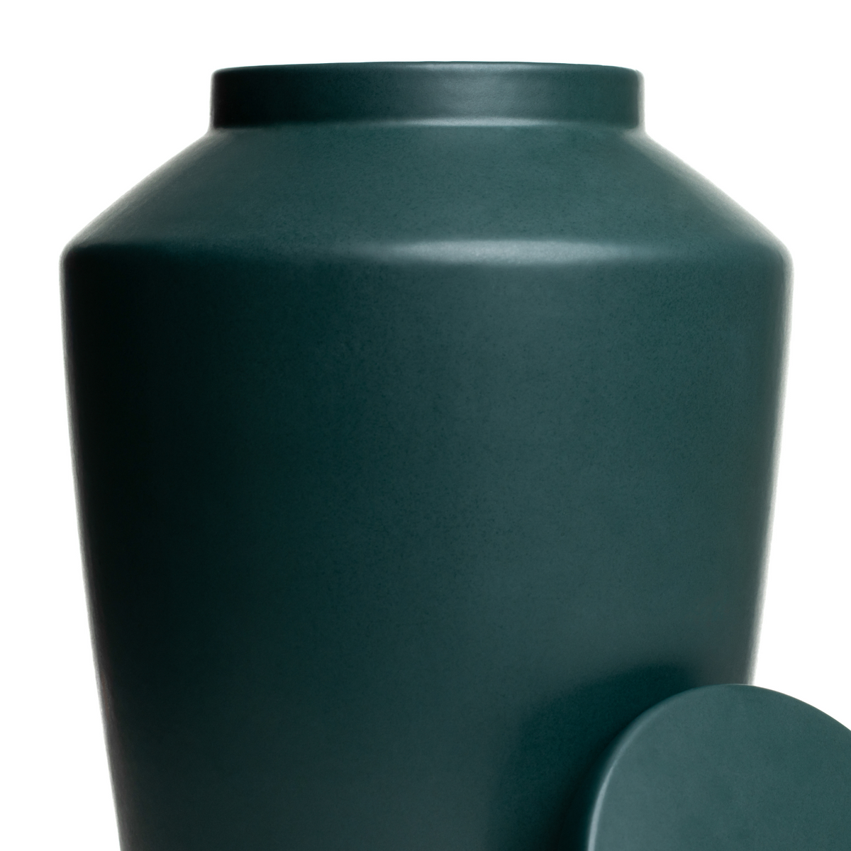 Macro detail of the smooth matte green glaze on a handcrafted stoneware keepsake urn.