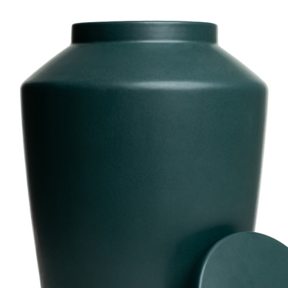 Macro detail of the smooth matte green glaze on a handcrafted stoneware keepsake urn.