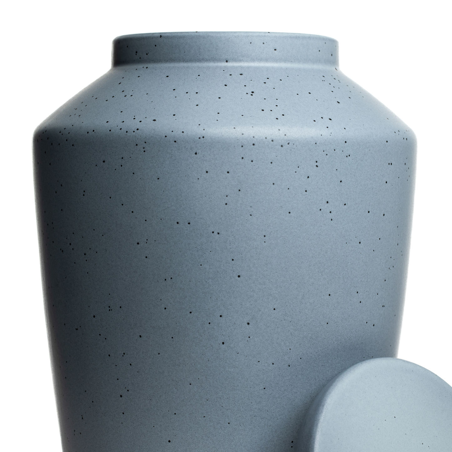 Macro detail of the smooth matte gray glaze on a handcrafted stoneware memorial urn.