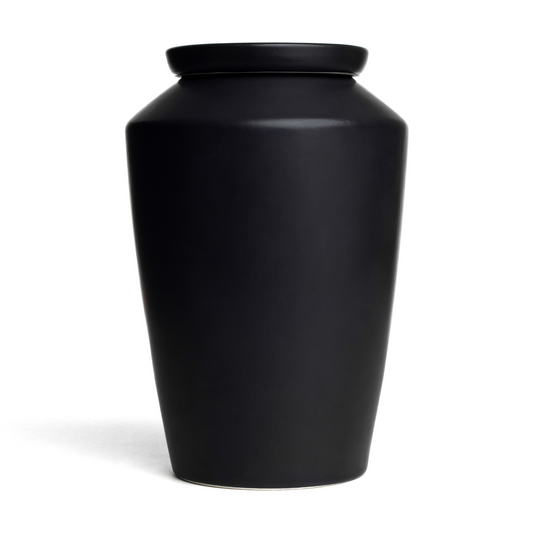 Handmade matte black ceramic cremation urn for adult ashes, minimalist modern memorial vessel for home decor.