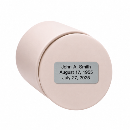 Soft Pink ceramic keepsake urn shown on its side with optional personalized memorial engraving plate